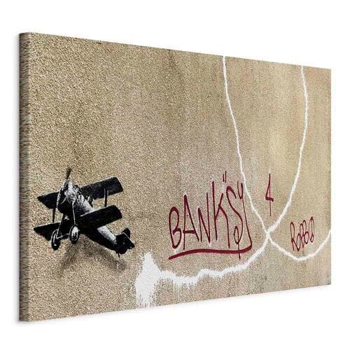 Obraz na płótnie Samolot Banksy - graffiti czerwone napisy na tle muralu 60×40 cm, płótno standard