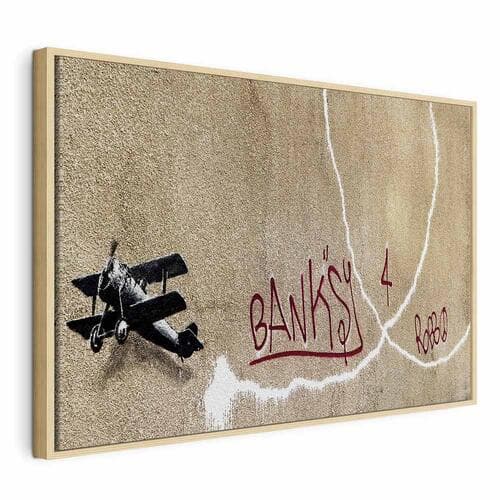 Leinwandbild Samolot Banksy - graffiti czerwone napisy na tle muralu 60×40 cm, Standardleinwand