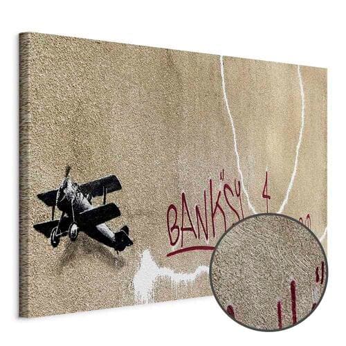 Obraz na płótnie Samolot Banksy - graffiti czerwone napisy na tle muralu 120×80 cm, płótno standard